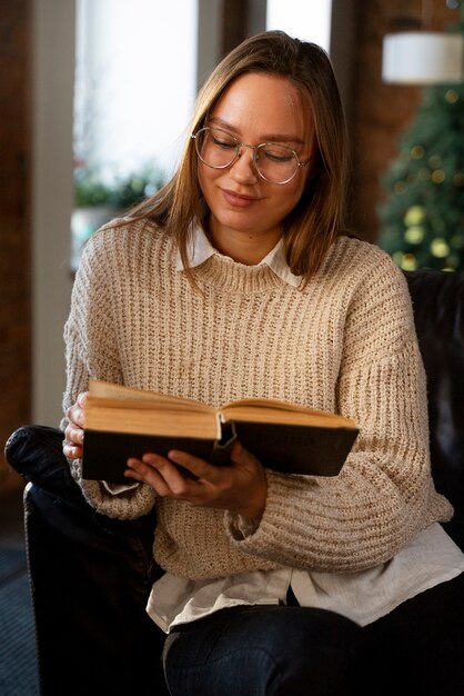 Free photo smiley woman holding book medium shot