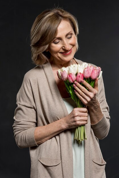 Smiley woman holding bouquet of flowers