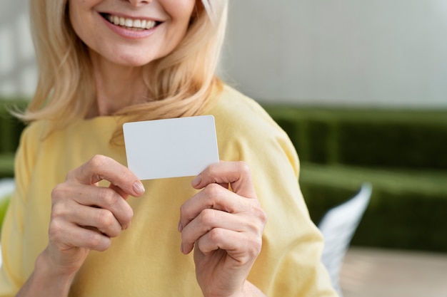 Smiley woman holding business card