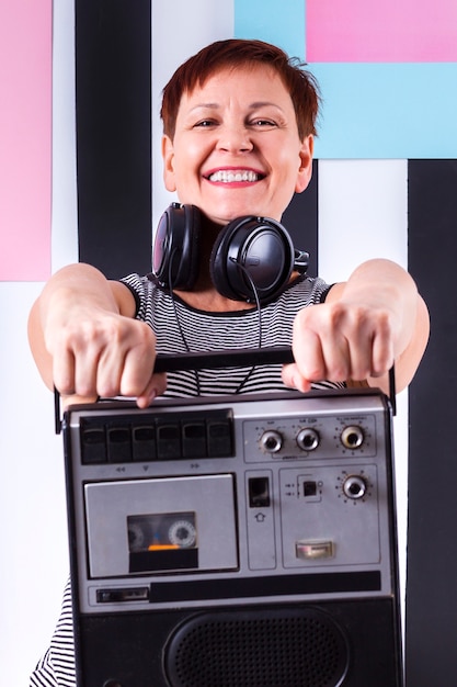 Smiley woman holding cassette