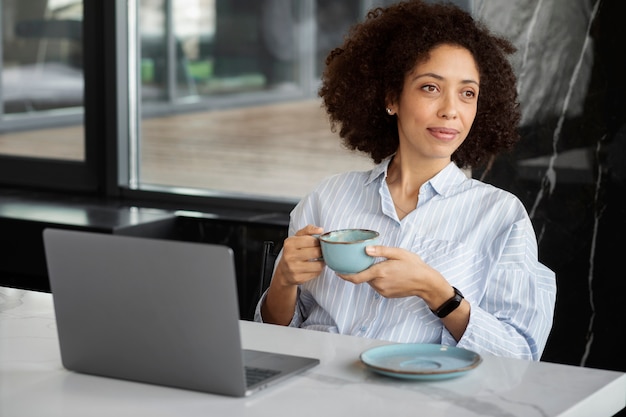 Free photo smiley woman holding coffee cup medium shot