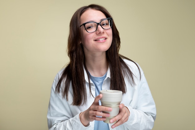 Free photo smiley woman holding coffee cup medium shot