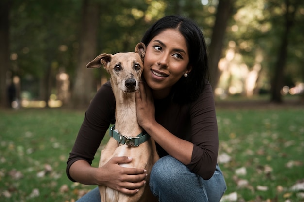 Smiley woman holding dog front view