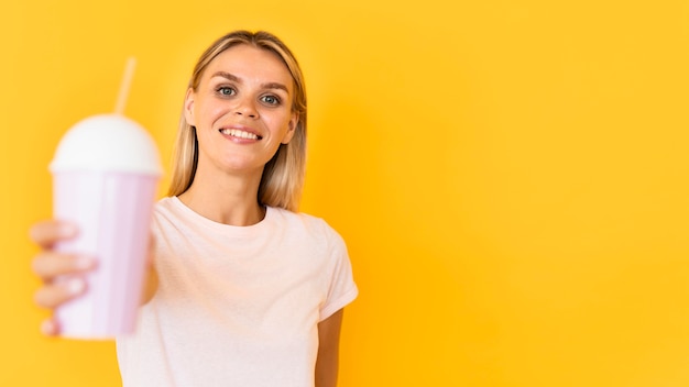 Smiley woman holding drink