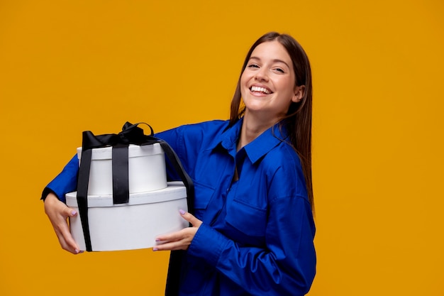 Smiley woman holding gifts medium shot