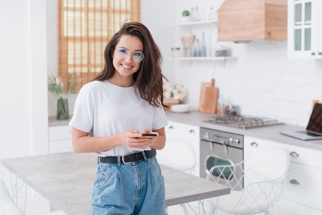 Smiley woman holding her phone