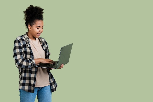 Smiley woman holding laptop