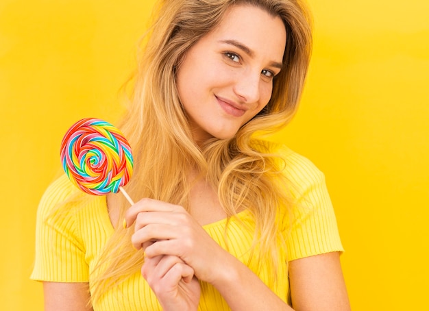 Smiley woman holding lollipop