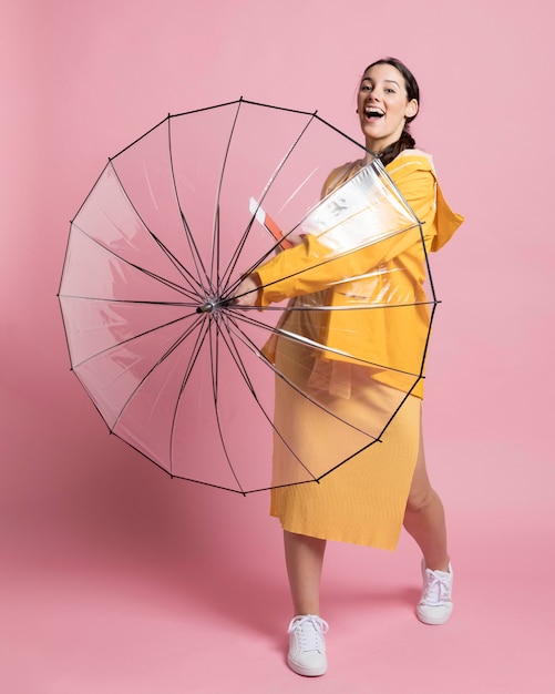 Smiley woman holding an opened umbrella