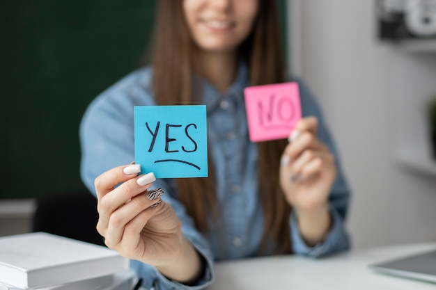 Free photo smiley woman holding post its