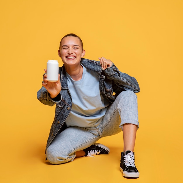 Free photo smiley woman holding soda can