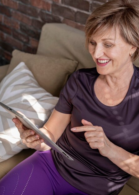 Smiley woman holding tablet close up