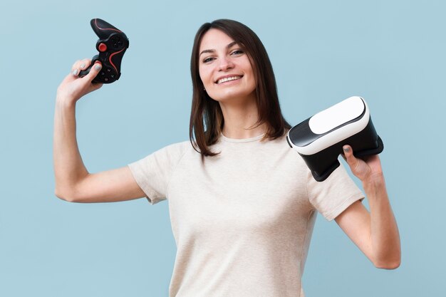 Smiley woman holding virtual reality headset