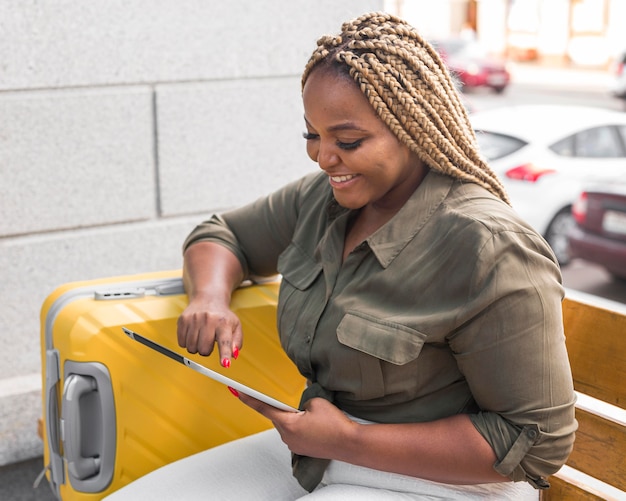 Smiley woman looking on her tablet