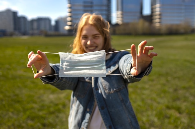 Free photo smiley woman mask free outdoors front view