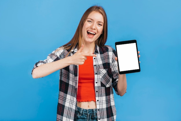 태블릿 모형을 가리키는 웃는 여자