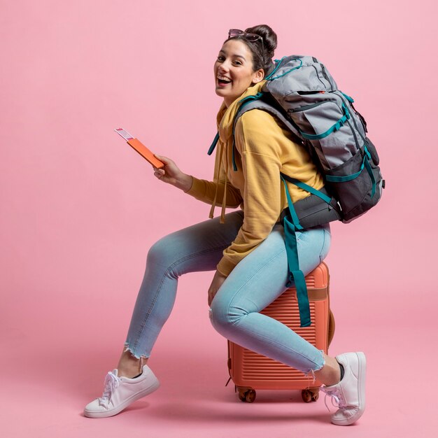 Smiley woman posing on her baggage