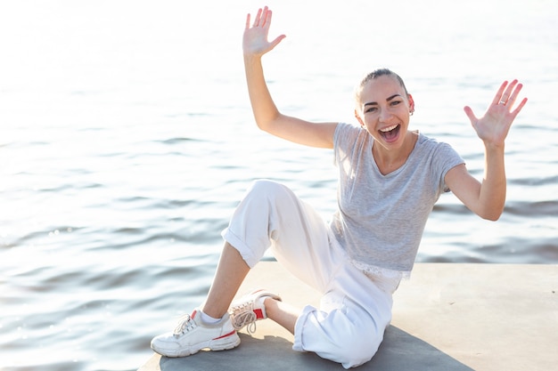 Donna di smiley che propone vicino al lago