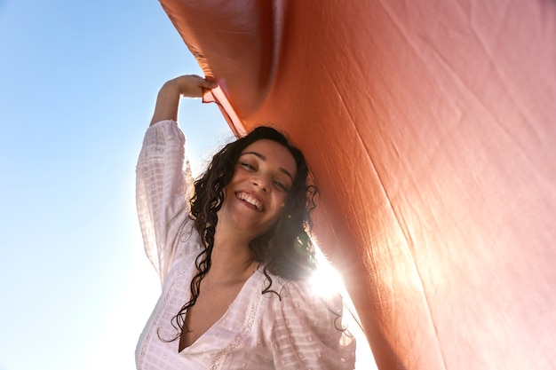 Smiley woman posing outdoors low angle