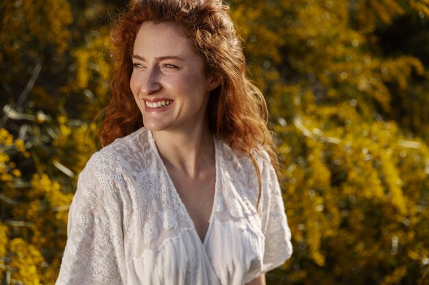 Smiley woman posing outdoors medium shot