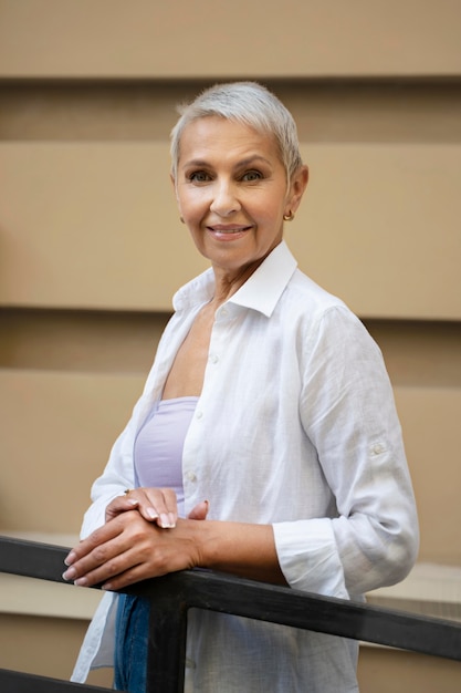 Smiley woman posing outside medium shot