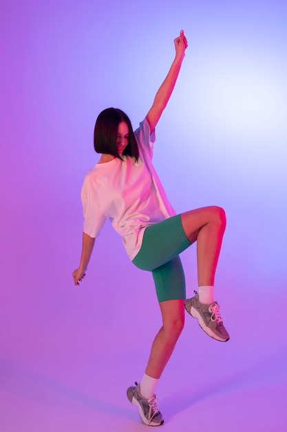 Free photo smiley woman posing in studio full shot