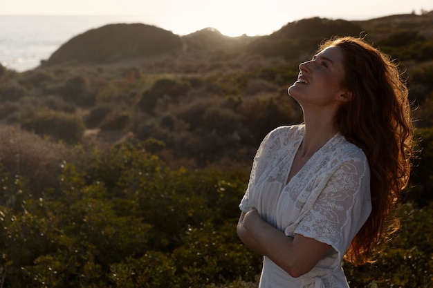 Free photo smiley woman posing in white dress medium shot