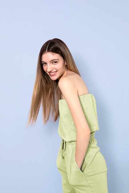 Free photo smiley woman posing with blue background