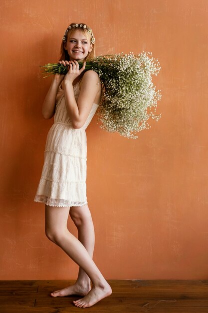 花の花束でポーズをとるスマイリー女性