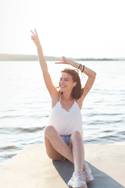 Foto gratuita donna di smiley che propone con le sue mani in su