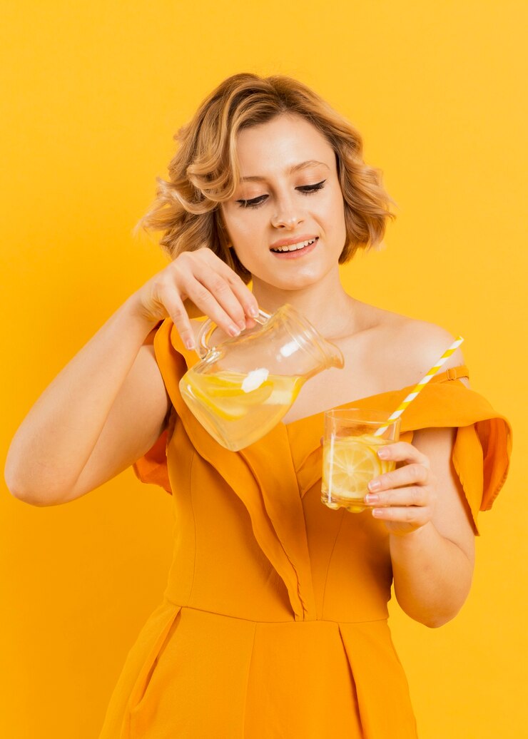 Free Photo smiley woman pouring lemonade