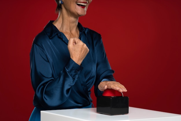 Free photo smiley woman pressing buzzer side view