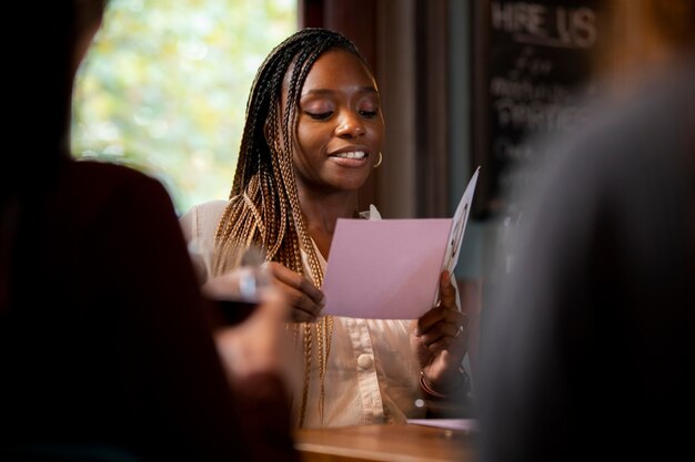 Smiley woman reading card close up