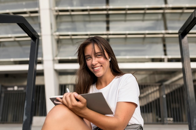 Smiley woman reading outdoors