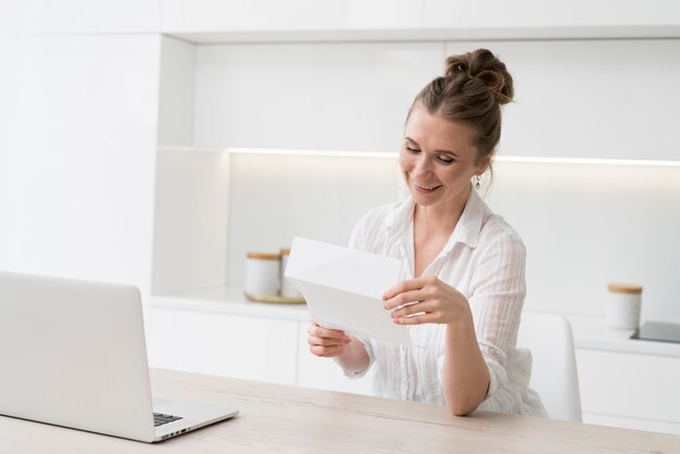 Smiley woman reading paper