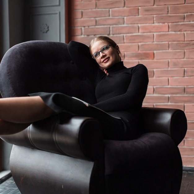 Free photo smiley woman relaxing on couch