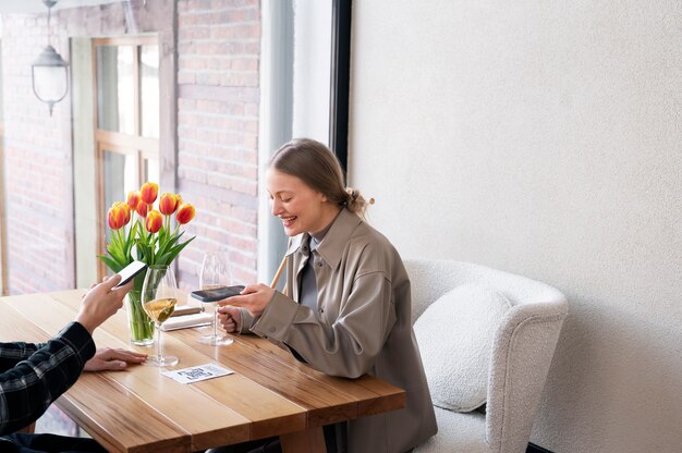 Smiley woman scanning qr code at restaurant