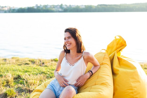 Smiley woman sitting on beanbag 