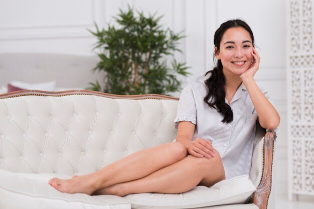 Smiley woman sitting on couch