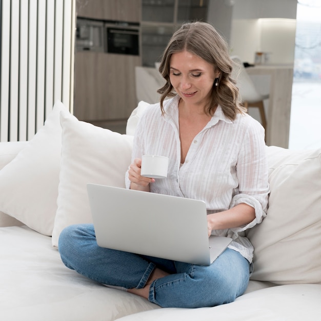 Smiley woman sitting on couch