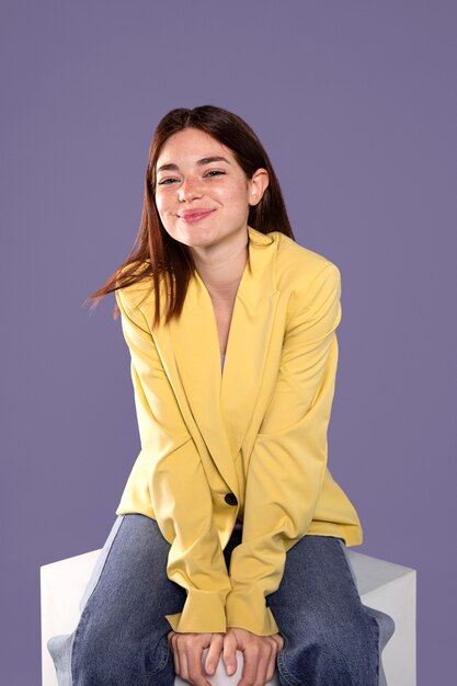 Smiley woman sitting medium shot