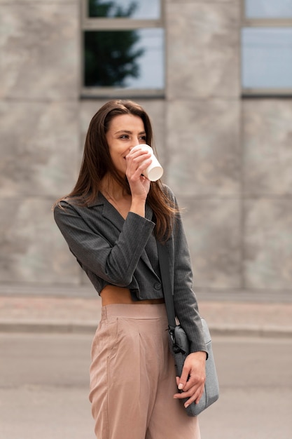 Smiley woman standing in a clean urban space