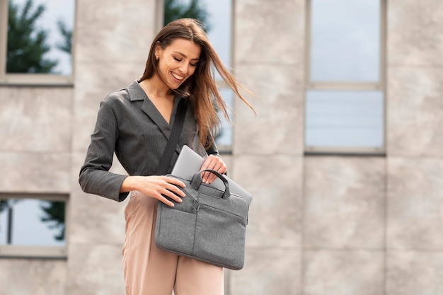 Smiley woman standing in a clean urban space