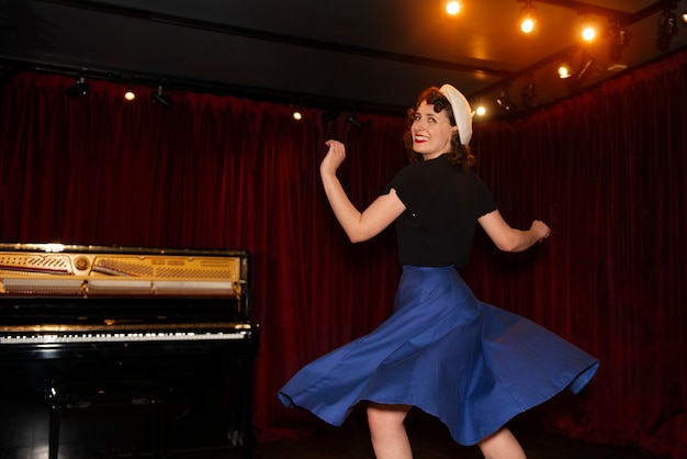 Free photo smiley woman swing dancing side view