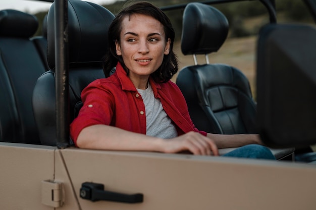 Smiley woman traveling alone by car