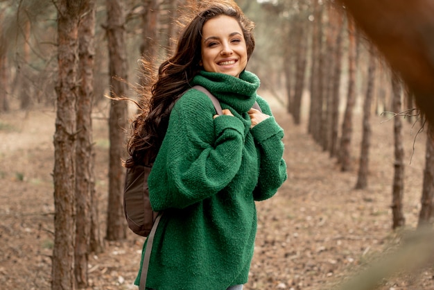 Smiley woman traveling with backpack