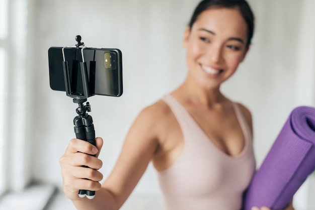 Smiley woman vlogging with her phone