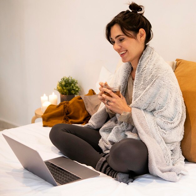 Smiley woman watching a tv show on the laptop