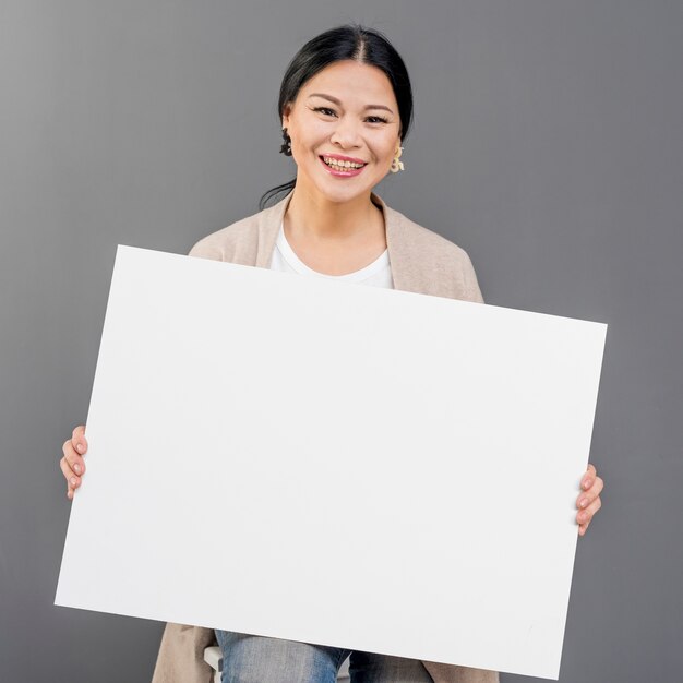 Smiley woman with blank paper sheet