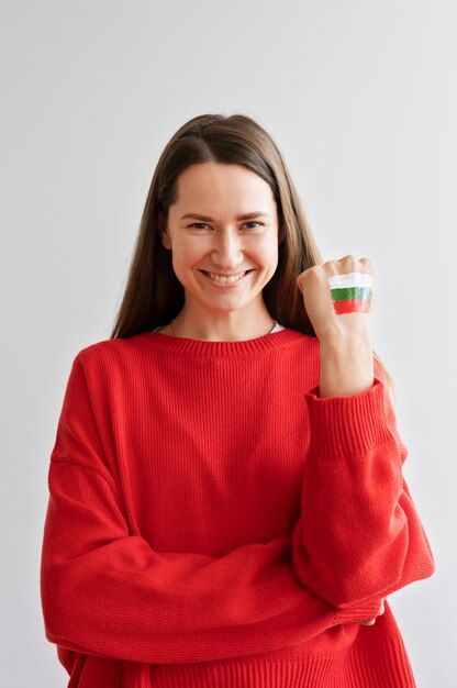 Smiley woman with bulgarian flag painted on her hand